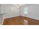 Bright dining room features hardwood floors, neutral colors, and a view to the kitchen at 256 Teresa Ln, Loganville, GA 30052