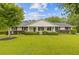 Charming home featuring a well-manicured lawn, attractive shrubbery and a welcoming front porch at 256 Teresa Ln, Loganville, GA 30052