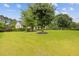 Inviting home with a lush front yard, showcasing mature trees and landscaping at 256 Teresa Ln, Loganville, GA 30052