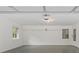 Clean, well-lit garage with white walls, a sealed concrete floor and two windows at 256 Teresa Ln, Loganville, GA 30052