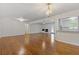 Open-concept living room with fireplace, white walls and gleaming hardwood floors at 256 Teresa Ln, Loganville, GA 30052