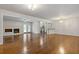 Spacious living room with a fireplace, gleaming hardwood floors and view of the kitchen at 256 Teresa Ln, Loganville, GA 30052