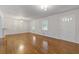 Open-concept living room featuring gleaming hardwood floors and neutral colored walls at 256 Teresa Ln, Loganville, GA 30052