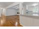 Open-concept living room with view of the kitchen, gleaming hardwood floors and neutral colored walls at 256 Teresa Ln, Loganville, GA 30052