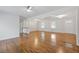 Open living room boasts gleaming hardwood floors, recessed lighting, and neutral paint scheme at 256 Teresa Ln, Loganville, GA 30052
