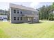 A spacious backyard with a covered patio and large windows allowing ample natural light into the home at 8 Foothills Trl, Sharpsburg, GA 30277