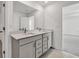 Bathroom with double vanity sinks, sleek cabinetry, and a large mirror at 8 Foothills Trl, Sharpsburg, GA 30277