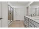 Bathroom featuring a double vanity, a glass shower, and sleek tile at 8 Foothills Trl, Sharpsburg, GA 30277