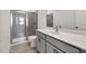 Bathroom featuring shower with glass door, gray tile, and vanity with white countertops at 8 Foothills Trl, Sharpsburg, GA 30277