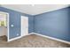 This bedroom features soft carpet and a door for easy access to other areas at 8 Foothills Trl, Sharpsburg, GA 30277