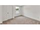 Bright bedroom features neutral carpeting and a window for natural light at 8 Foothills Trl, Sharpsburg, GA 30277