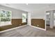 Bedroom with large windows, a door, and a view to the adjacent bathroom at 8 Foothills Trl, Sharpsburg, GA 30277