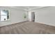 Large bedroom featuring a tray ceiling, carpeted floors, and natural light at 8 Foothills Trl, Sharpsburg, GA 30277