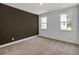 Neutral bedroom with two windows offering natural light, and plush carpeting at 8 Foothills Trl, Sharpsburg, GA 30277