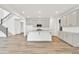 Bright, open-concept kitchen with stainless appliances, light wood flooring, and a center island at 8 Foothills Trl, Sharpsburg, GA 30277