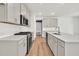 Modern kitchen with stainless steel appliances, white cabinetry, and quartz countertops on a large island at 8 Foothills Trl, Sharpsburg, GA 30277