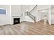 Inviting living room with fireplace, staircase, and laminate flooring at 8 Foothills Trl, Sharpsburg, GA 30277