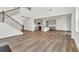 Open-concept living space with hardwood floors, staircase, and modern kitchen at 8 Foothills Trl, Sharpsburg, GA 30277