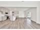 Bright open space with hardwood floors connecting kitchen to living area at 8 Foothills Trl, Sharpsburg, GA 30277