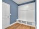 Mudroom featuring blue wall, bench with storage cubbies, and white beadboard at 8 Foothills Trl, Sharpsburg, GA 30277
