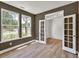 Cozy home office with French doors, laminate flooring, and natural light at 8 Foothills Trl, Sharpsburg, GA 30277