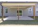 Covered patio with wooden support beams, a ceiling fan, and a concrete slab at 8 Foothills Trl, Sharpsburg, GA 30277