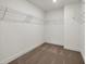 Empty walk-in closet with carpeted flooring and wire shelving at 8 Foothills Trl, Sharpsburg, GA 30277