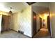 Hallway featuring vintage wallpaper and doors leading to other rooms at 1305 Lenox Cir, Atlanta, GA 30306