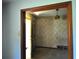 Open doorway showcasing vintage wallpaper and light fixture in the hallway at 1305 Lenox Cir, Atlanta, GA 30306