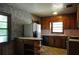 Kitchen with wood cabinetry, vintage wallpaper, and appliances at 1305 Lenox Cir, Atlanta, GA 30306