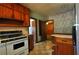Retro kitchen features vintage appliances, wood cabinets, and colorful floral wallpaper at 1305 Lenox Cir, Atlanta, GA 30306