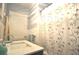 Bright bathroom with white tile and a decorative shower curtain over a tub at 1332 Euclid Ave # C, Atlanta, GA 30307