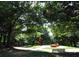 A scenic community park with mature trees, sculptures, walking path, and comfortable benches at 1332 Euclid Ave # C, Atlanta, GA 30307