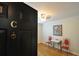 Elegant foyer with dark door, hardwood floors, unique accent furniture, and a bright ceiling light at 1332 Euclid Ave # C, Atlanta, GA 30307