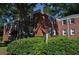 A charming two-story red brick apartment building, nestled among lush trees and shrubbery at 1332 Euclid Ave # C, Atlanta, GA 30307