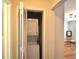 Laundry closet with white stacked washer and dryer, space-saving design at 1332 Euclid Ave # C, Atlanta, GA 30307