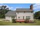Spacious backyard featuring a two-story home with a deck, lush greenery, and a well-maintained lawn at 1644 Beaver Creek Ln, Snellville, GA 30078