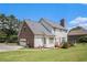 Home exterior featuring brick accents, a spacious yard, attached garage and an inviting deck at 1644 Beaver Creek Ln, Snellville, GA 30078