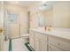 Bright bathroom featuring a tiled floor, toilet, sink, and a window with natural light at 1644 Beaver Creek Ln, Snellville, GA 30078