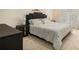 Modern bedroom featuring a sleek black headboard, neutral carpet and white linens for a contemporary feel at 1644 Beaver Creek Ln, Snellville, GA 30078
