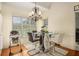 Bright breakfast nook featuring a modern glass table, stylish chandelier, and view of the lush outdoors at 1644 Beaver Creek Ln, Snellville, GA 30078