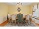 Formal dining room with hardwood floors, a statement chandelier, and an elegant dining set for sophisticated meals at 1644 Beaver Creek Ln, Snellville, GA 30078