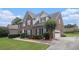 Elegant brick home featuring a well-maintained lawn, mature landscaping, attached garage, and inviting curb appeal at 1644 Beaver Creek Ln, Snellville, GA 30078