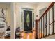 Welcoming foyer boasts hardwood floors, decorative front door, and staircase with wrought iron details at 1644 Beaver Creek Ln, Snellville, GA 30078