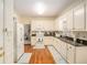Classic kitchen with white cabinets, granite countertops, stainless steel appliances, and hardwood floors at 1644 Beaver Creek Ln, Snellville, GA 30078