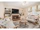 Cozy living room with warm fireplace, built-in bookshelves, and elegant furniture, creating an inviting ambiance at 1644 Beaver Creek Ln, Snellville, GA 30078
