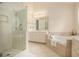 Bright main bathroom with double vanity, soaking tub, glass shower, and plenty of room to relax at 1644 Beaver Creek Ln, Snellville, GA 30078