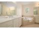 Bright main bathroom with double vanity, soaking tub, and large mirrors for a spa-like retreat at 1644 Beaver Creek Ln, Snellville, GA 30078