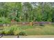 Expansive backyard with a playset, trampoline, and lush green grass at 270 Alcovy Reserve Way, Covington, GA 30014