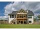 Generous backyard featuring a covered deck, stairs, and comfortable seating at 270 Alcovy Reserve Way, Covington, GA 30014